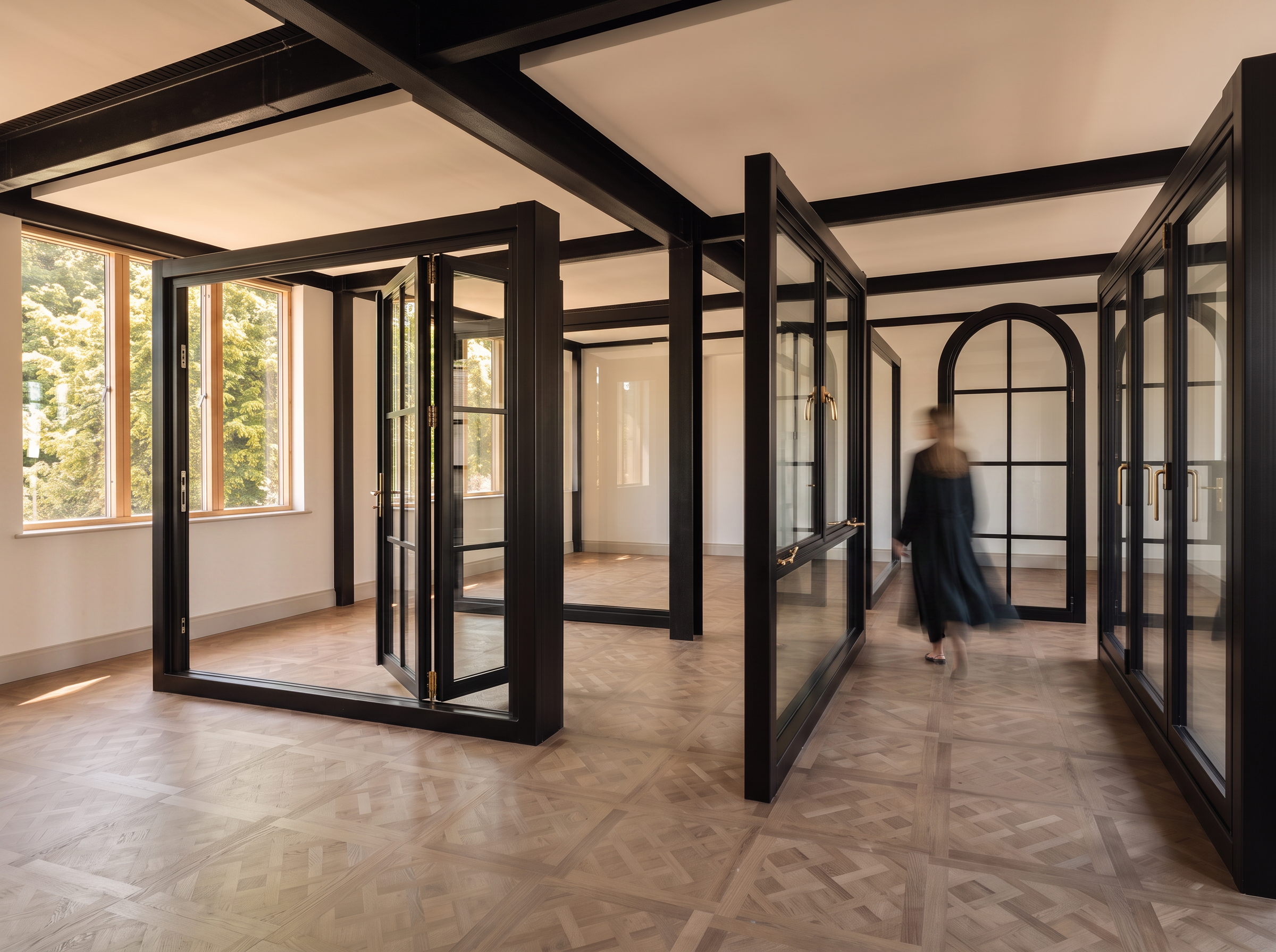 Steel-framed glazing in the studio-projects. showroom at dusk